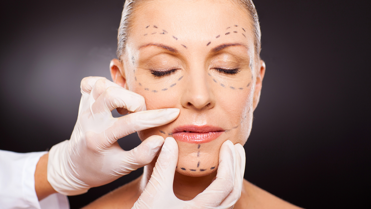 doctor hands on mid age woman